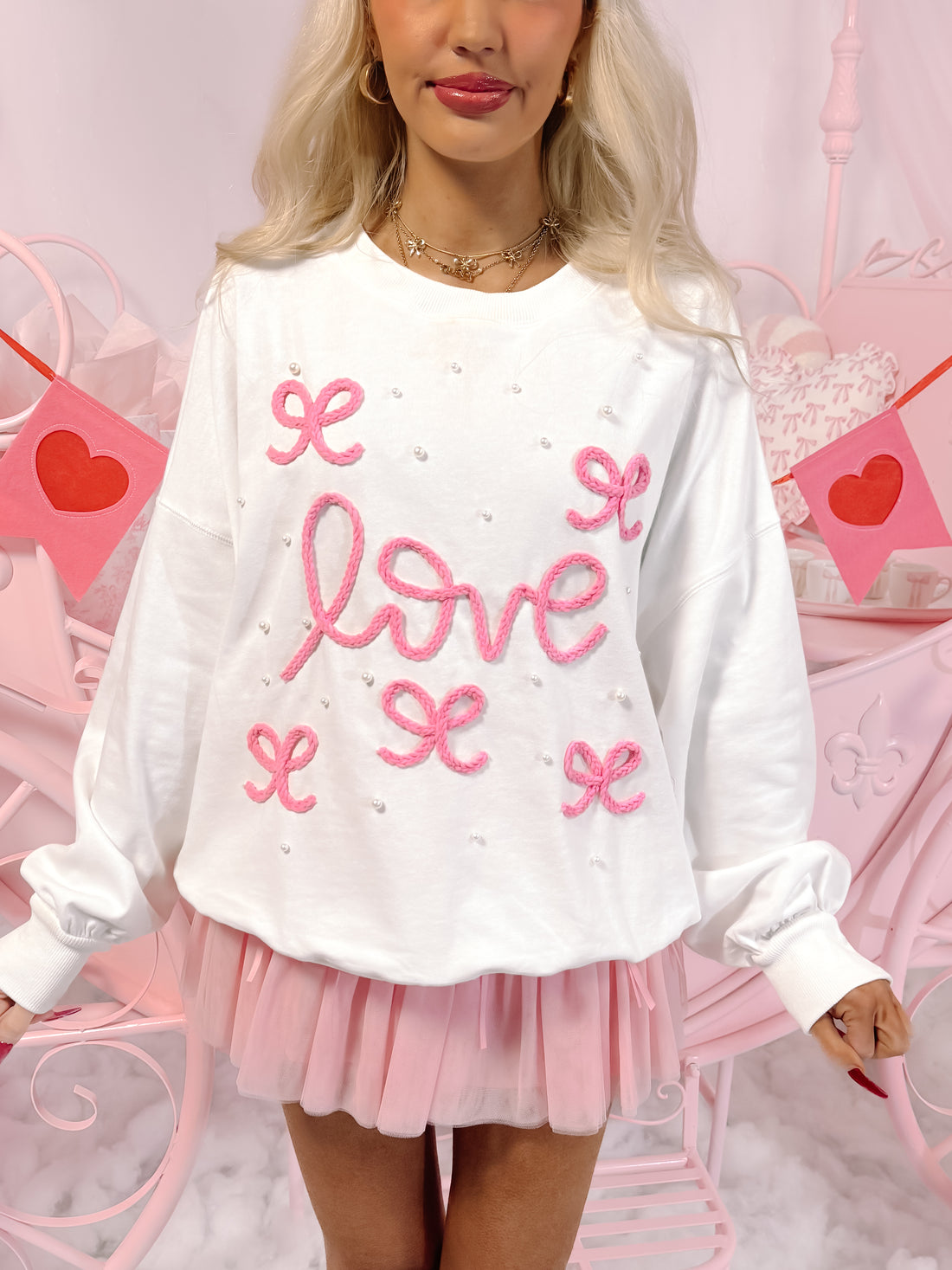 White Sweetheart Pearl Bow Crewneck sweater with pink embroidered "love" and bows.
