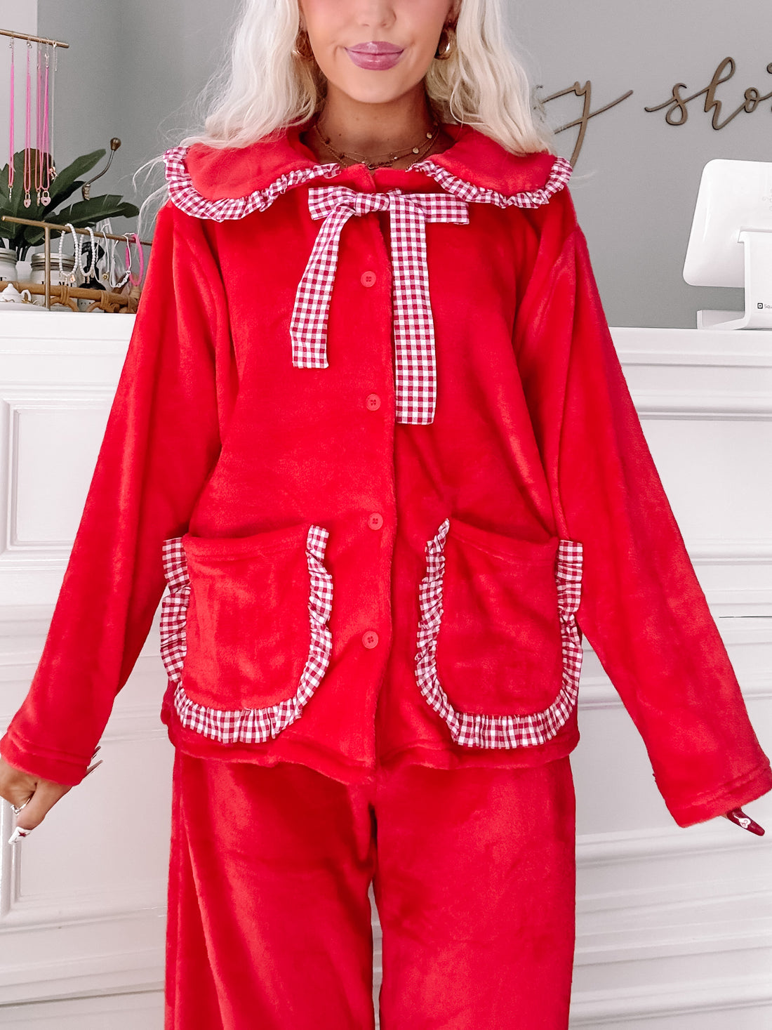 Red women's pajama set with gingham trim; cozy velour fabric.
