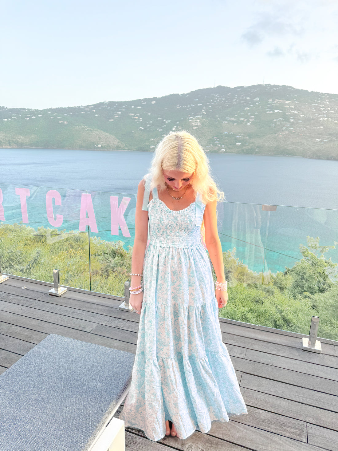 Sassy Shortcake Sweet Pea blue floral maxi with tie shoulders and flowing tiers on oceanfront deck.