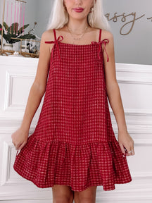 Red tweed mini dress with velvet straps and ruffle hem; perfect holiday party outfit.
