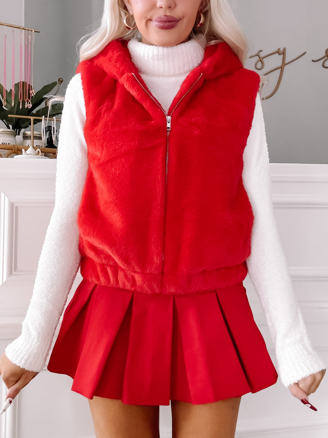 Red faux fur hooded vest for winter warmth
