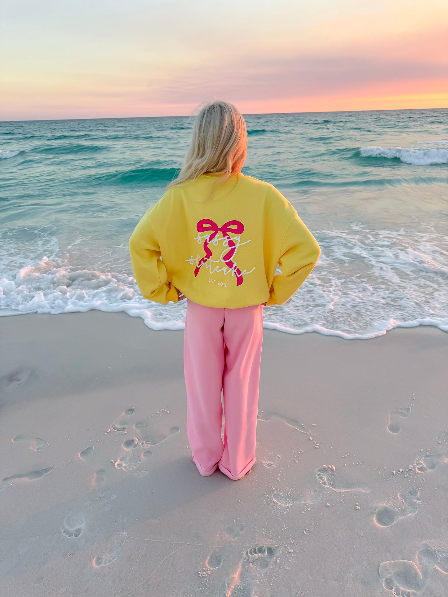 yellow crewneck on the beach