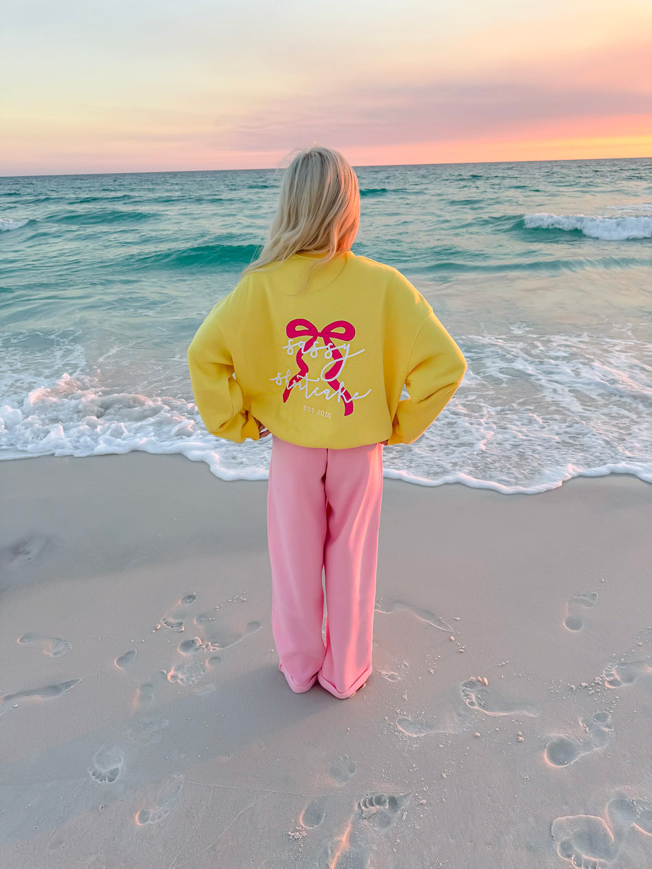 yellow crewneck on the beach