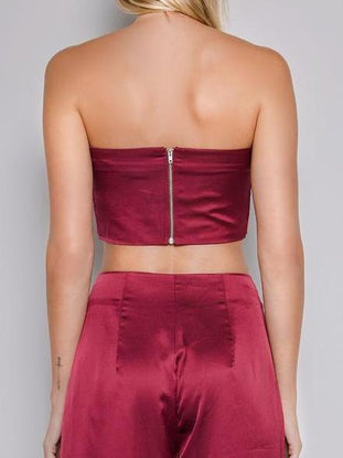 Burgundy satin crop top and wide-leg pants; back view showing zipper detail.
