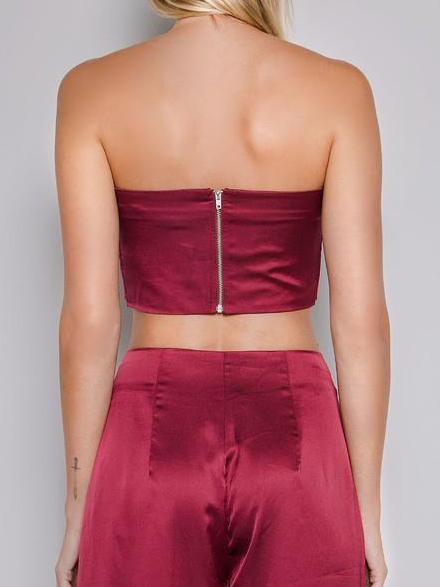 Burgundy satin crop top and wide-leg pants; back view showing zipper detail.
