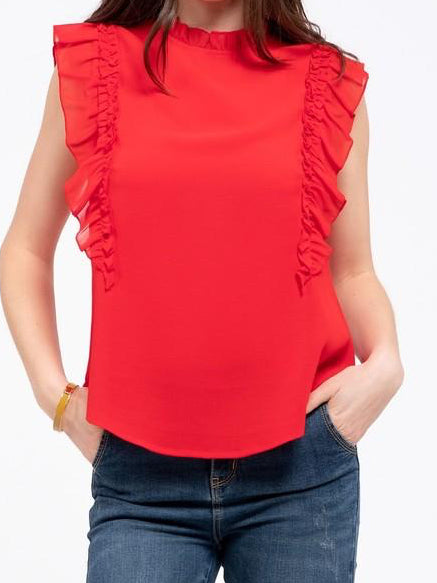 Red sleeveless blouse with ruffle trim, modeled over jeans.
