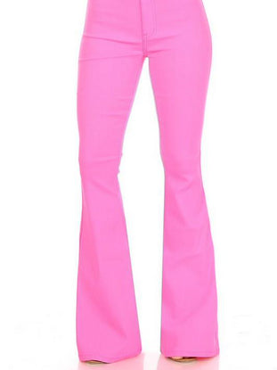 Hot pink flare jeans shown from the knees down, against a white background.
