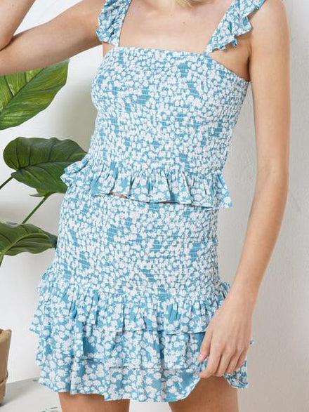 Blue floral print mini skirt and cropped top set with ruffled detailing.
