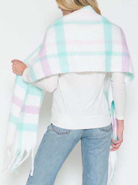 Soft, fringed pastel plaid scarf draped over shoulders; light mint, lavender, and white pattern.
