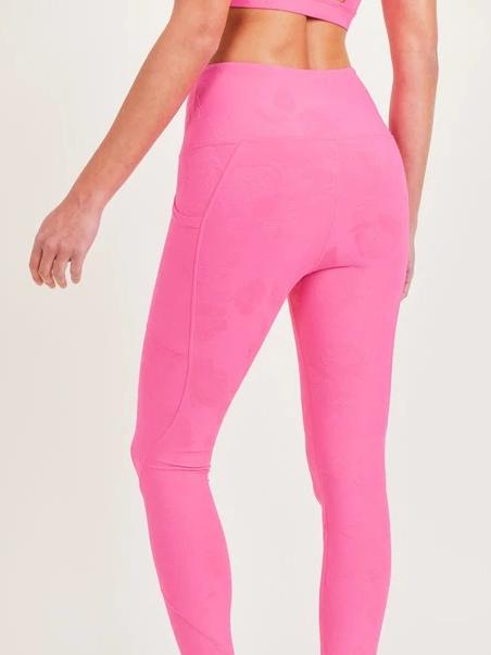 Hot pink leggings with subtle texture and side pockets;  shown from the back.

