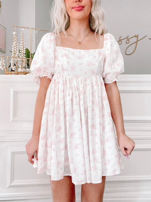 All Dolled Up Dress in pink floral print;  sweetheart neckline, puff sleeves, mini length.

