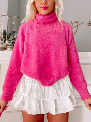 Fuzzy hot pink turtleneck sweater paired with a white ruffled mini skirt.
