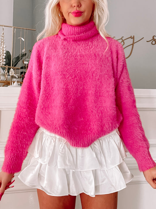 Fuzzy hot pink turtleneck sweater paired with a white ruffled mini skirt.