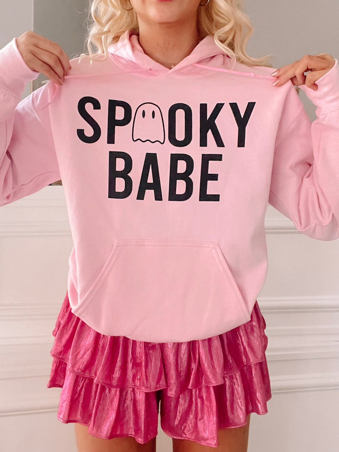 Pink Halloween hoodie featuring "Spooky Babe" text and a cute ghost graphic.
