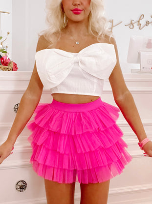 Hot pink tulle mini skirt with layered ruffles, shown on a model from Sassy Shortcake
