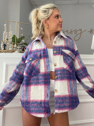 Purple, pink, and white plaid shacket on model.
