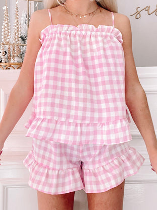 Pink gingham pajama set with ruffle trim; comfy shorts and cami top.
