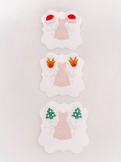 Sassy Shortcake Holiday Mini Earrings: Santa hat, reindeer, and Christmas tree designs.
