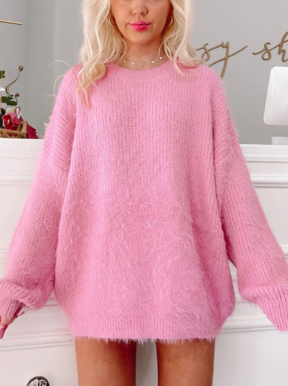 Pink fuzzy knit sweater; relaxed fit.
