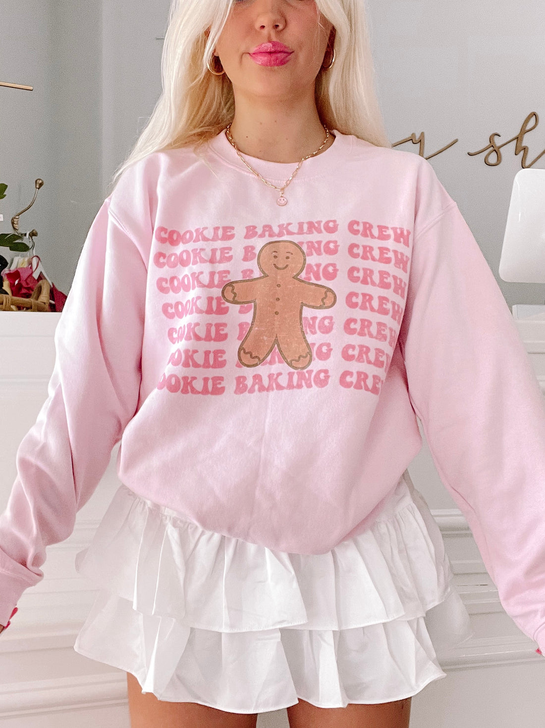 Pink Cookie Baking Crewneck sweatshirt featuring a gingerbread man graphic.
