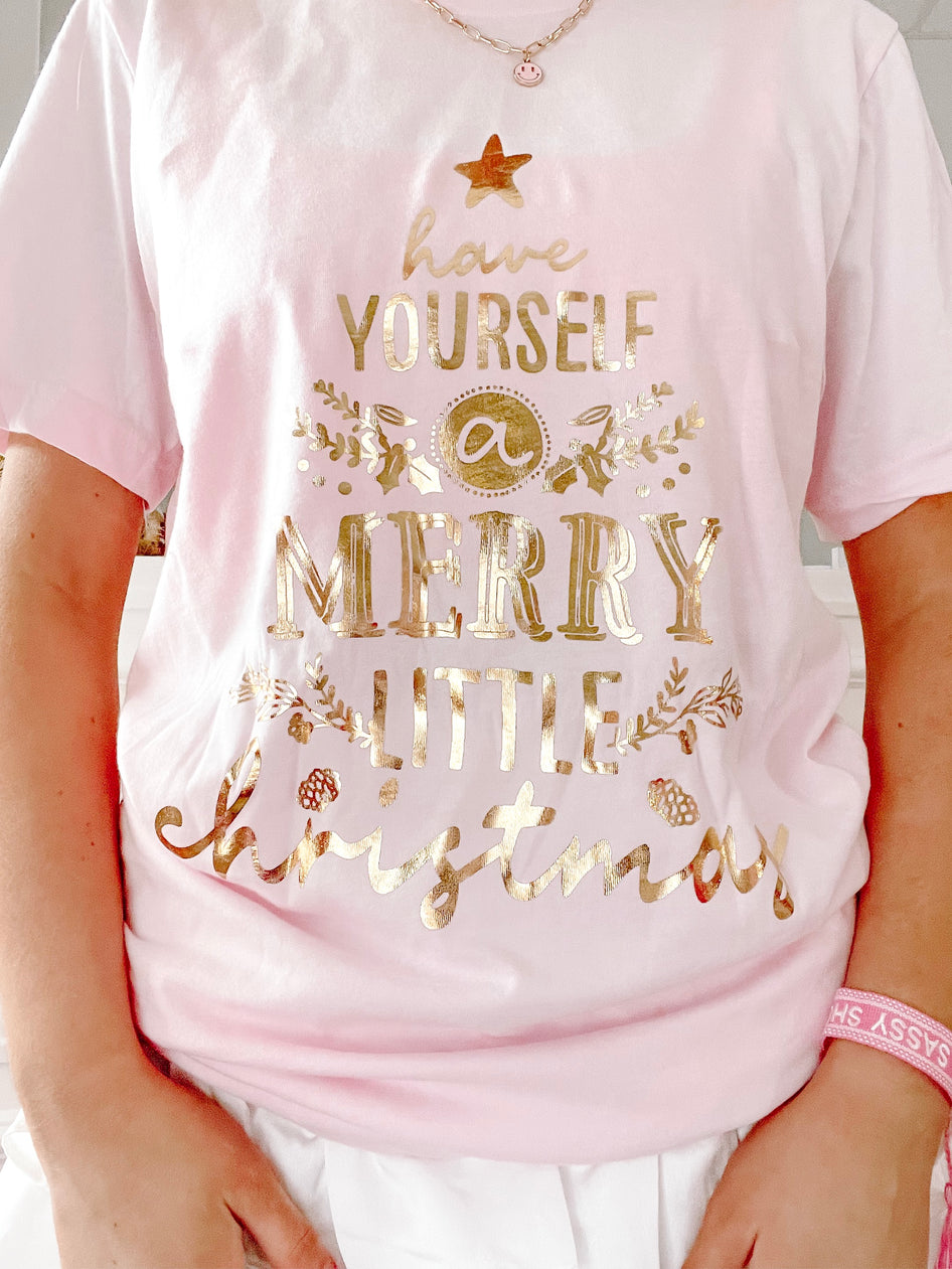 Pink Christmas tee with gold foil "Have Yourself a Merry Little Christmas" design.
