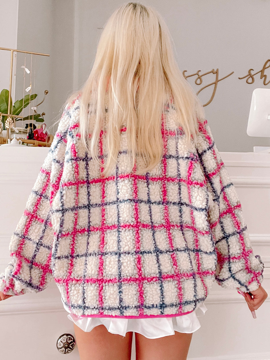 Cream-colored teddy jacket with pink and gray plaid pattern, shown from the back.
