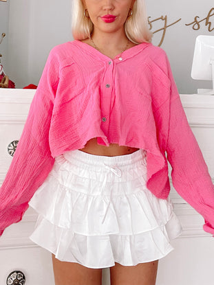 Bubble Me Up Top: Hot pink cropped button-down shirt and white ruffle shorts.
