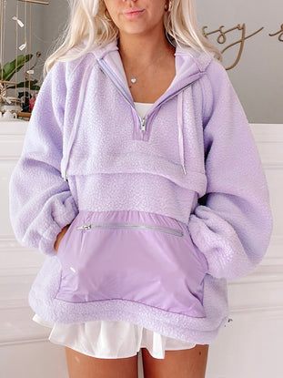 Lilac Pastel Pullover: Soft, fuzzy lilac pullover with half zip and contrasting purple nylon pocket.
