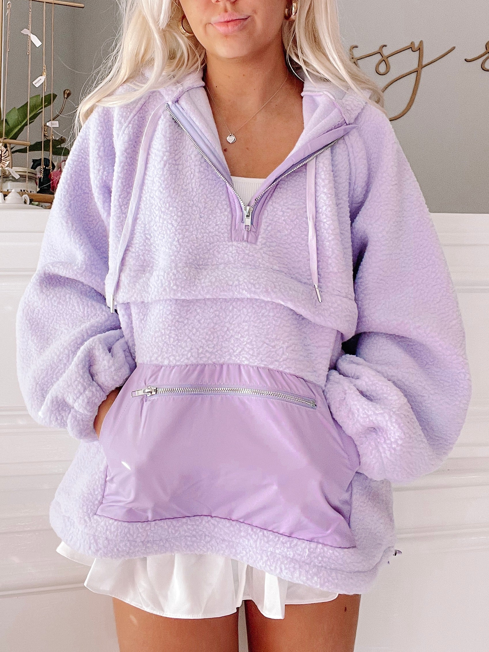 Lilac Pastel Pullover: Soft, fuzzy lilac pullover with half zip and contrasting purple nylon pocket.
