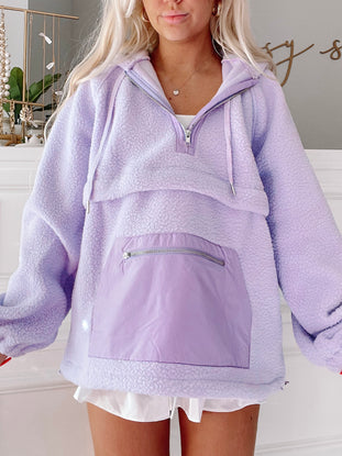 Lilac fleece pullover with contrasting purple nylon pocket detail.
