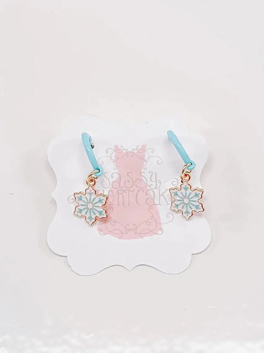 Ice Snowflake earrings with light blue hoops and gold snowflake charms.
