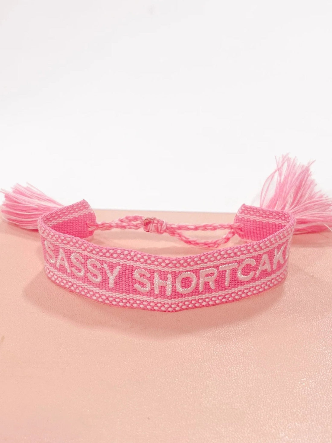 Pink Sassy Shortcake woven bracelet with tassels. Sassy Merch
