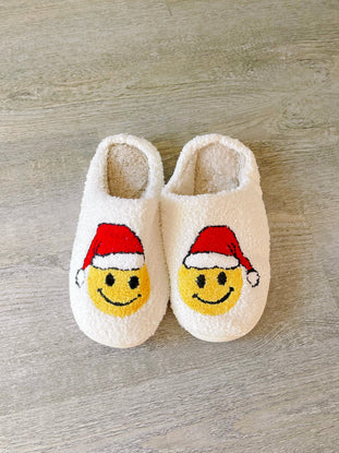 White Santa Smiley slippers with plush fleece lining for cozy comfort.
