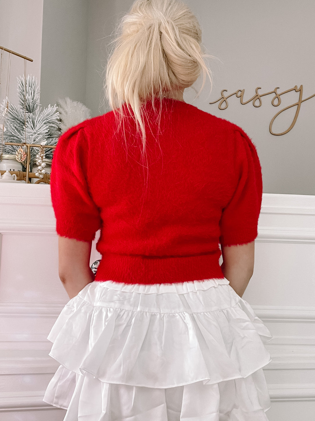 Red fuzzy short-sleeve sweater with puff shoulders, shown from the back.
