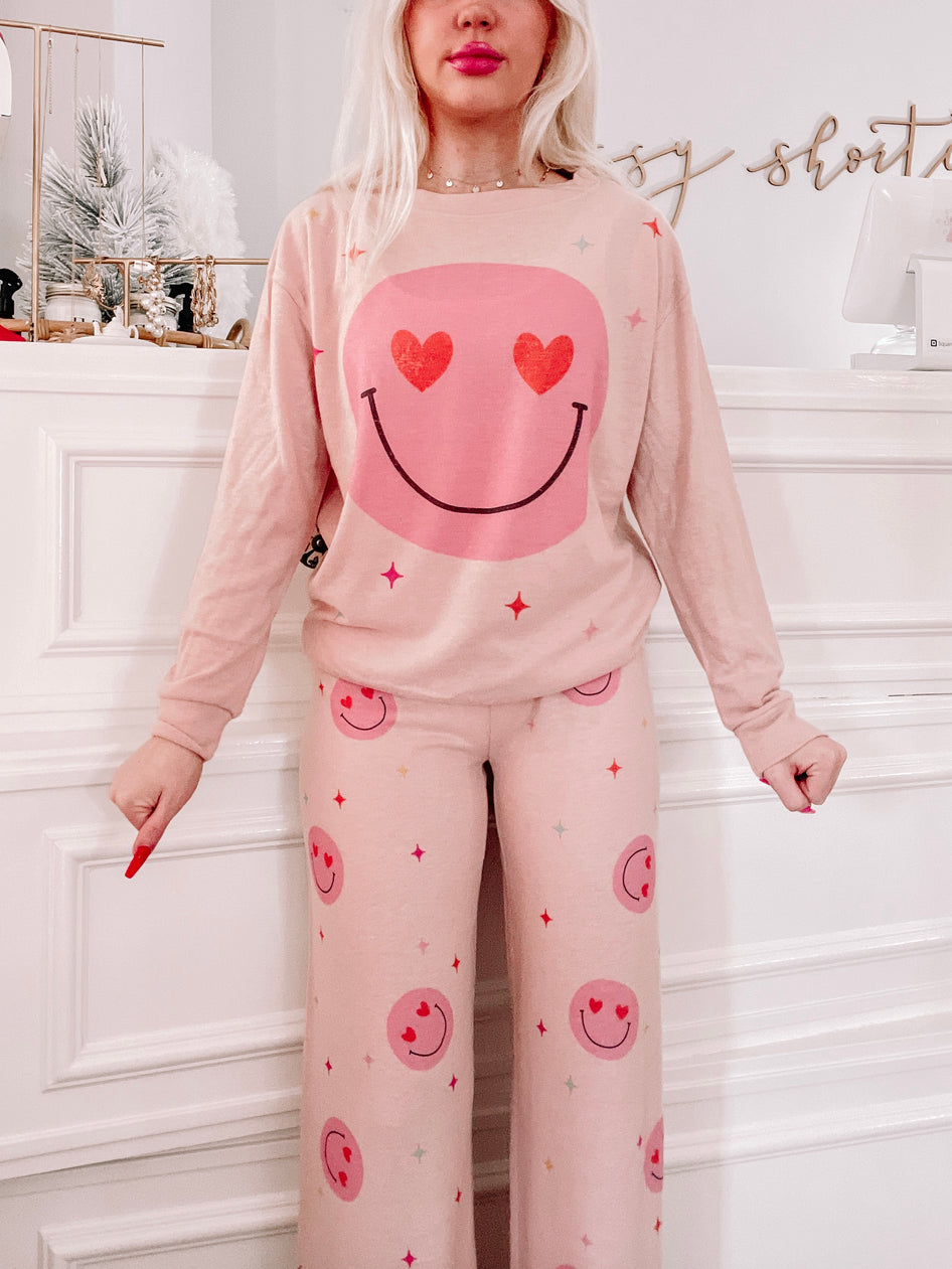 Pink Hearts & Charms PJ set: comfy pink pajama set featuring heart-eyed smiley faces.
