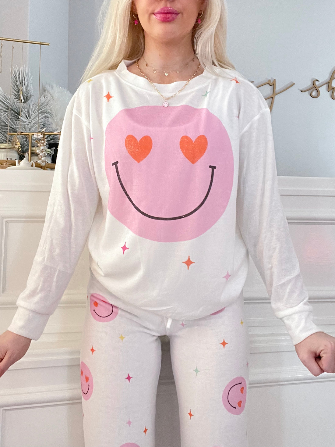 Hearts & Charms PJ Set in white featuring a smiley face long sleeve top and coordinating pants.

