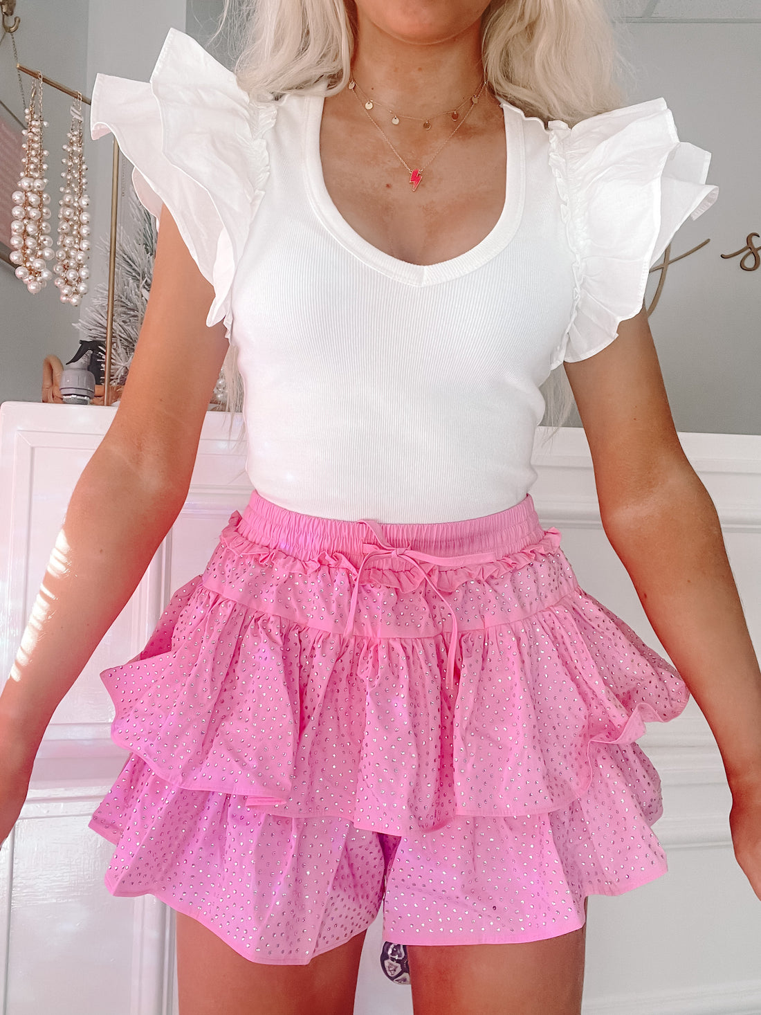 Pink rhinestone Flirtatious skirt; layered ruffle design.

