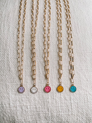 Happy Smiles gold chain necklaces with enamel smiley face charms in assorted colors.
