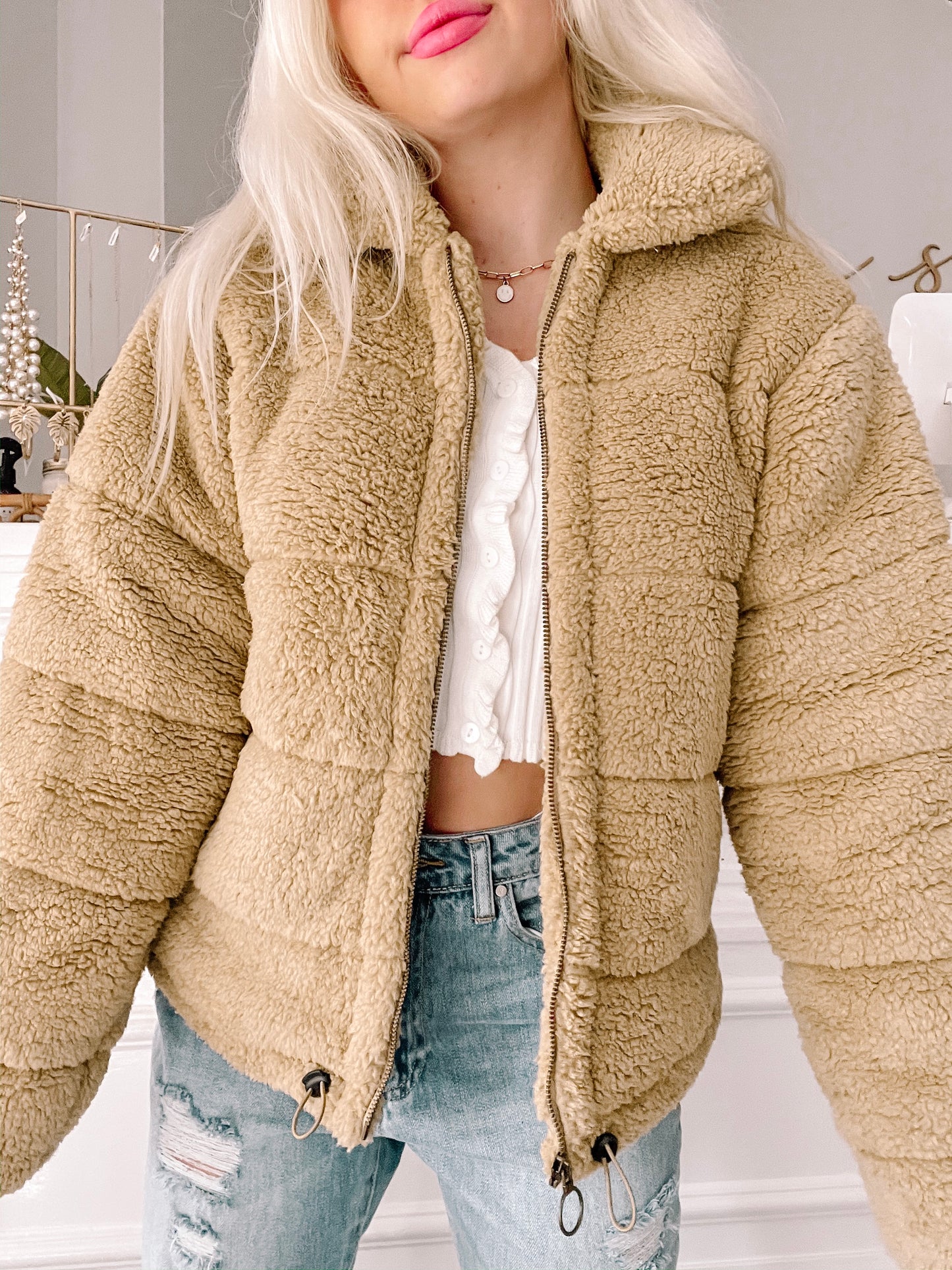 Tan teddy bear fleece zip-up jacket, quilted, shown worn with jeans.
