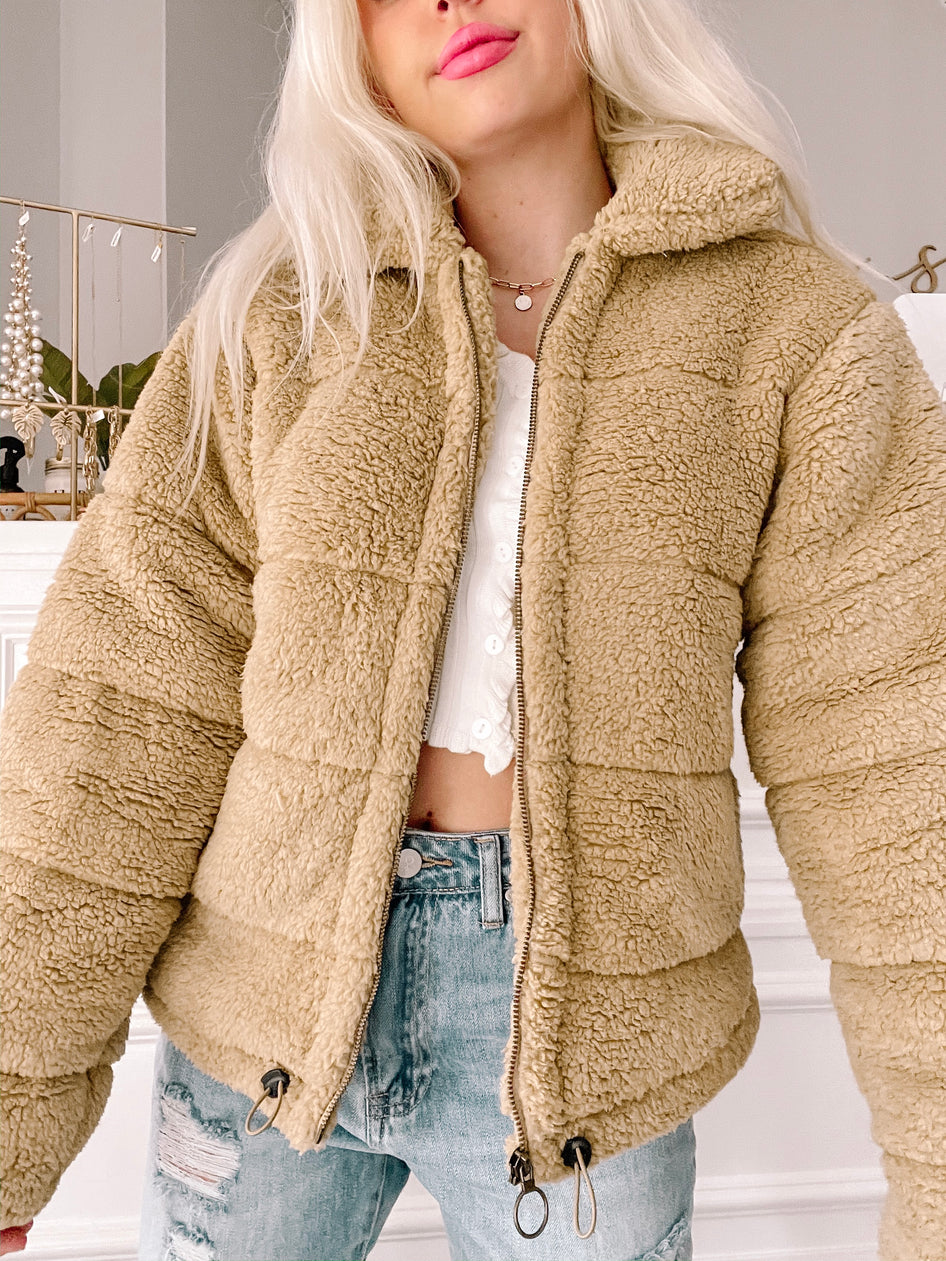 Tan teddy bear fleece zip-up jacket; soft, cozy winter outerwear.
