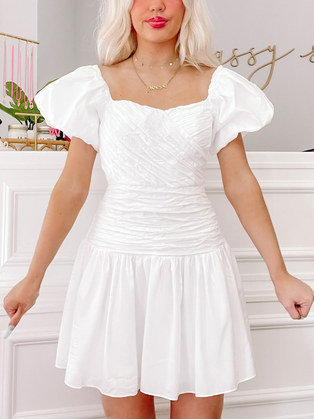White Dear Lover puff-sleeve mini dress with ruched bodice and tiered skirt.
