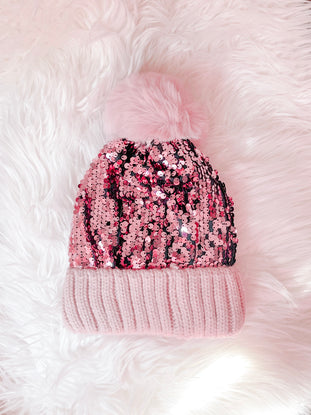 Pink sequin beanie with faux fur pompom
