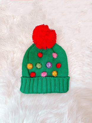 Green knit Oh Christmas Tree beanie with colorful pom-poms and large red pom-pom top.
