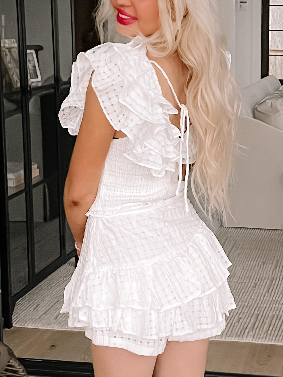 White eyelet ruffle shorts set; tiered ruffles and a smocked bodice.
