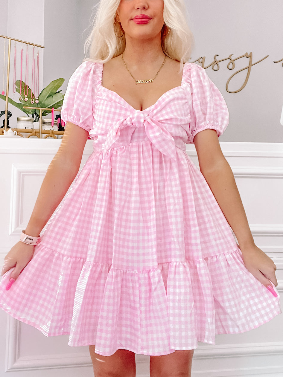 Pink gingham Pretty Privilege dress with puff sleeves and bow detail
