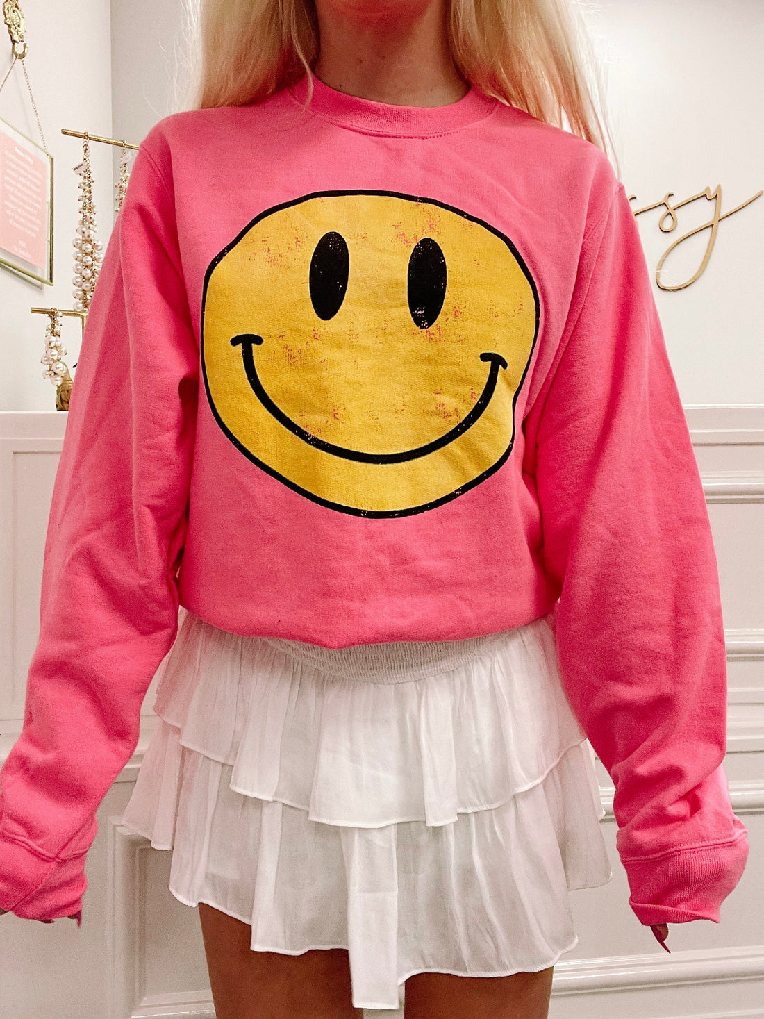 Pink Frown Upside Down Sweatshirt featuring a vintage-style yellow smiley face graphic from Sassy Shortcake
