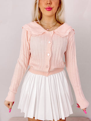 Lovesick Pink Cardigan:  Ribbed knit pink cardigan with Peter Pan collar and pearl buttons.
