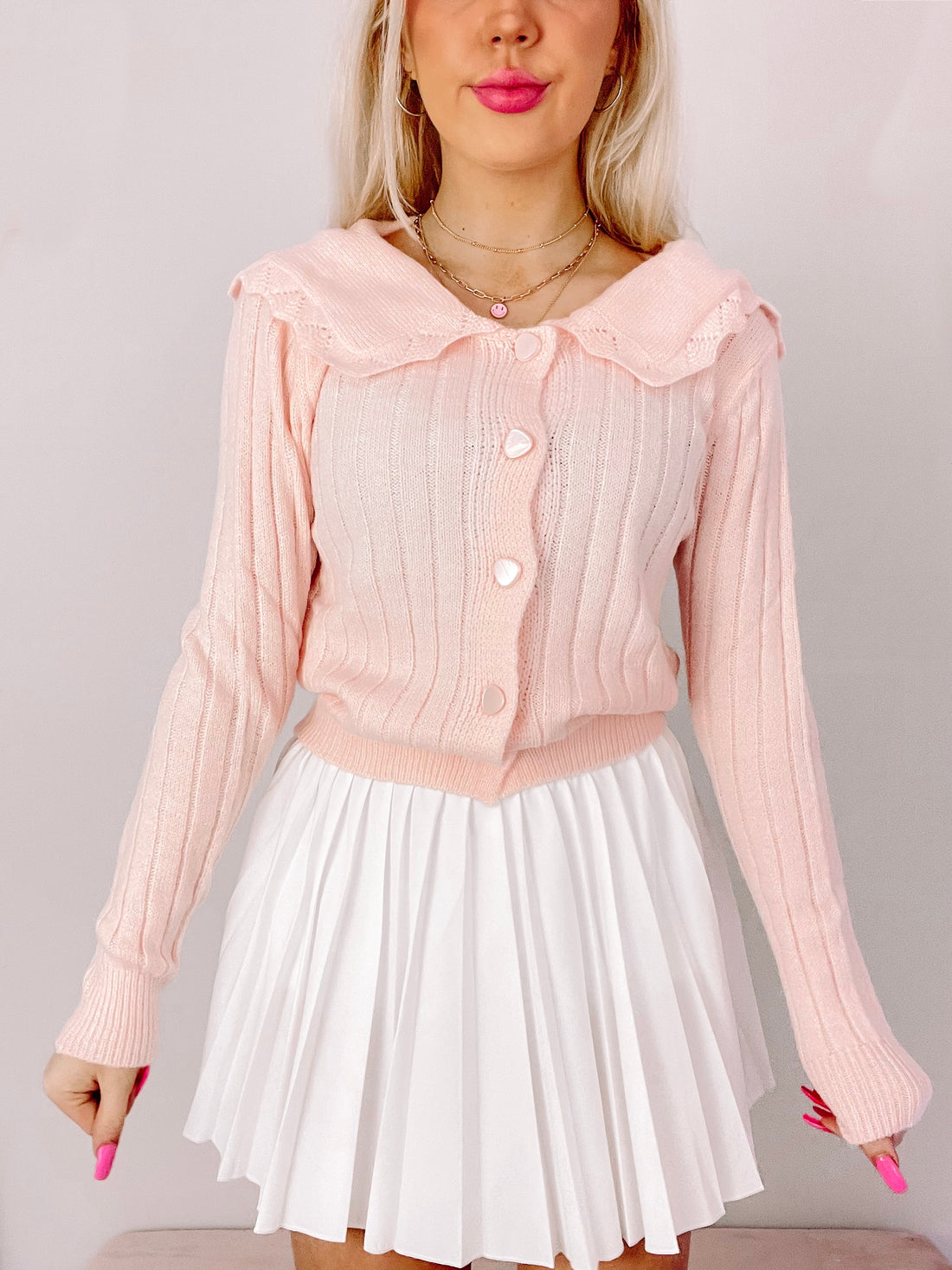 Lovesick Pink Cardigan:  Ribbed knit pink cardigan with Peter Pan collar and pearl buttons.
