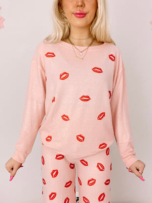 Pink Kiss Kiss PJ set with red lip print.
