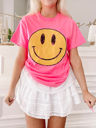 Pink Frown Upside Down tee with yellow smiley face graphic
